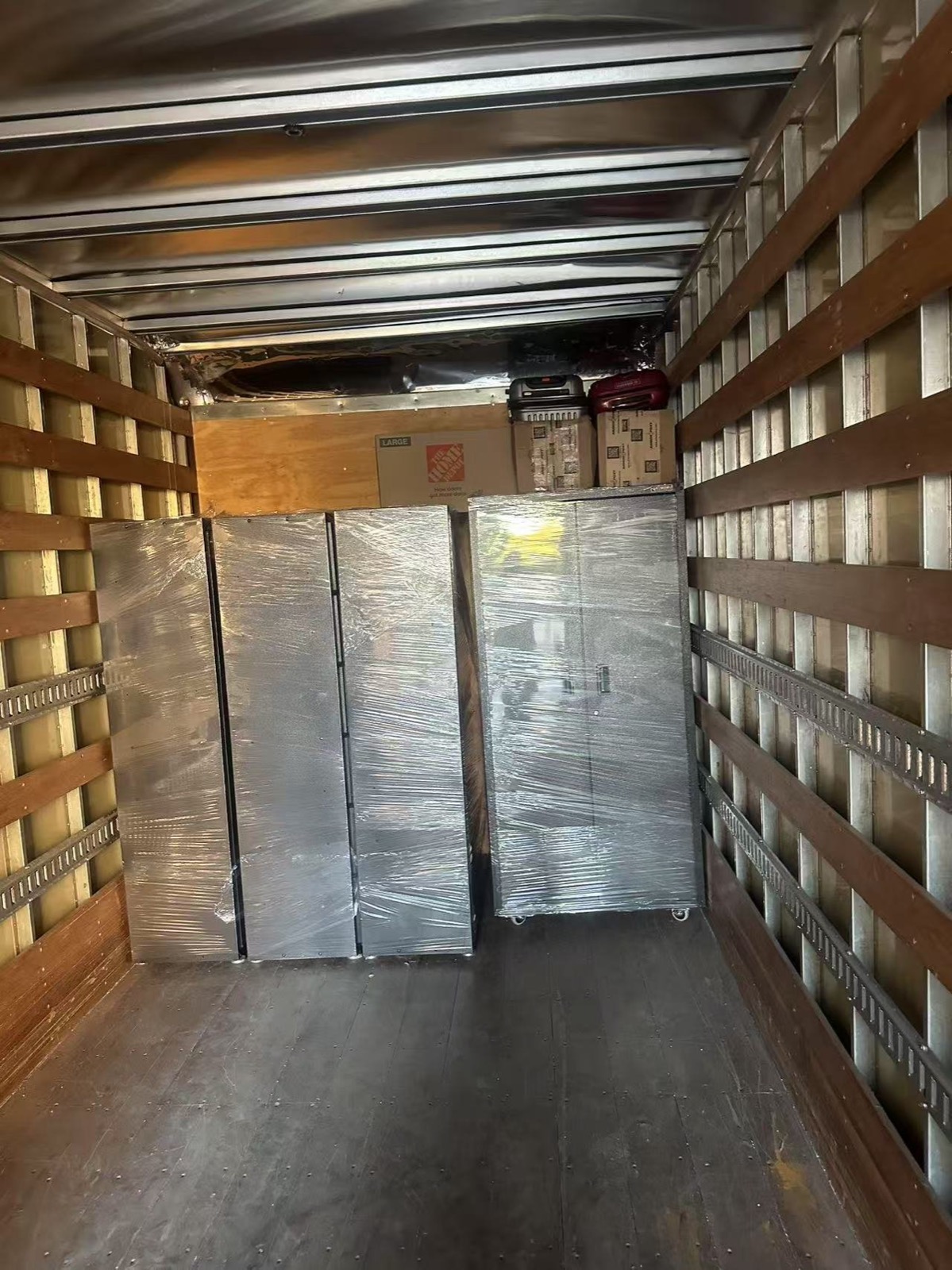 Professional movers using specialty equipment for a piano moving job